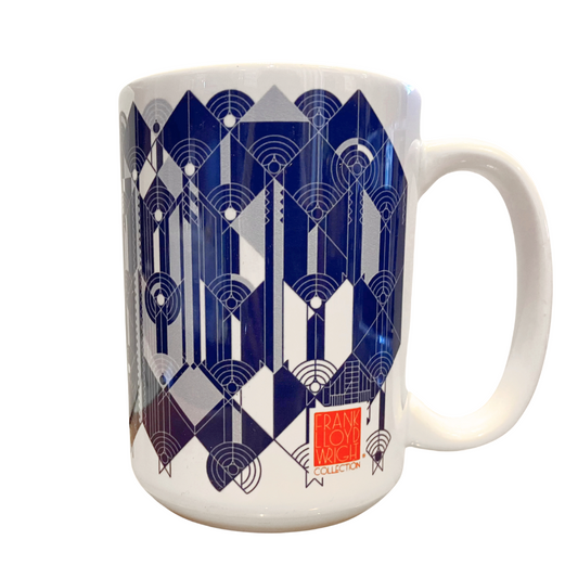 Frank Lloyd Wright April Showers mug featuring a blue abstract geometric design inspired by Wright's unpublished Liberty Magazine cover from 1927-1928. The 15oz ceramic mug showcases squares at 45-degree angles and intersecting circular patterns, reflecting Wright's admiration for Japanese prints. The mug is dishwasher and microwave safe with a full-sized handle.